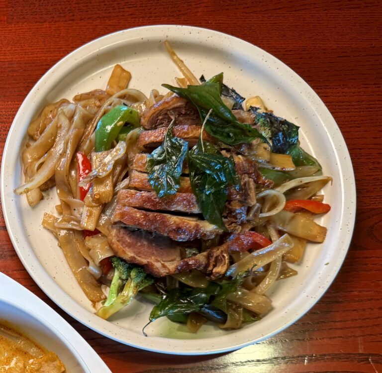 Roasted duck drunken noodles with wide rice noodles, Thai basil and bell peppers